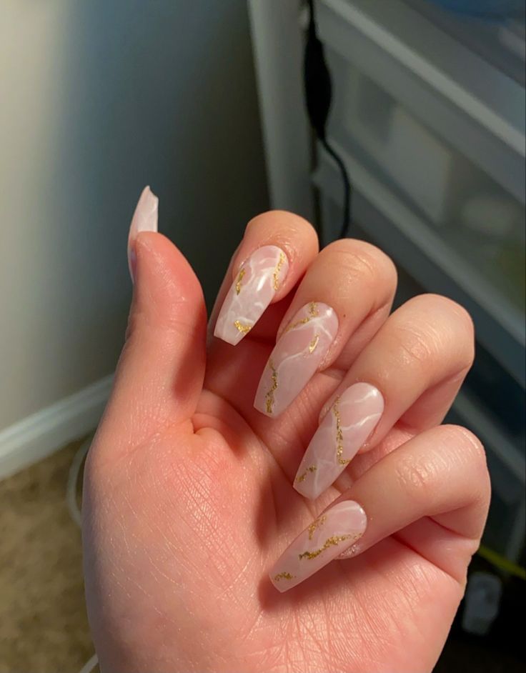 Sophisticated Soft Pink Marble Nail Design with Elegant Gold Accents.