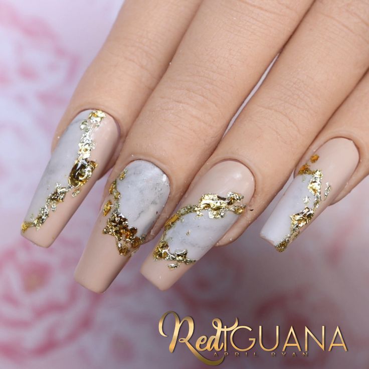 Luxurious Marble and Nude Nail Design with Gold Foil Accents