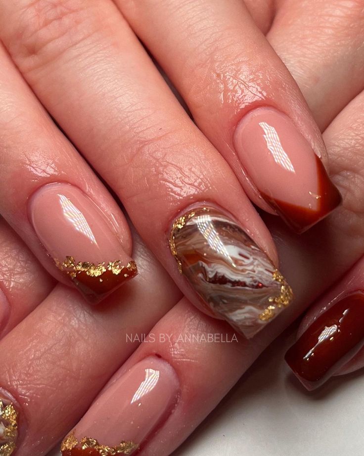 Sophisticated Earthy-Toned Nail Design with Marble Accent and Gold Details