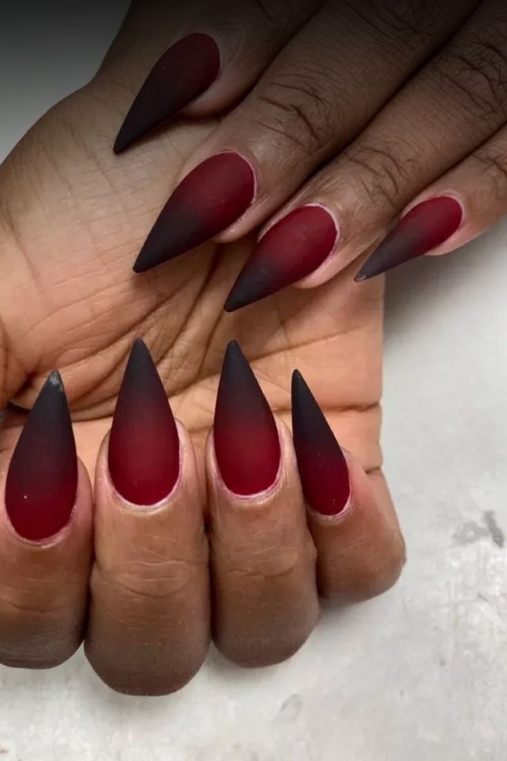 Striking Gradient Stiletto Nails: Deep Red to Black with Matte Finish for a Bold Statement.