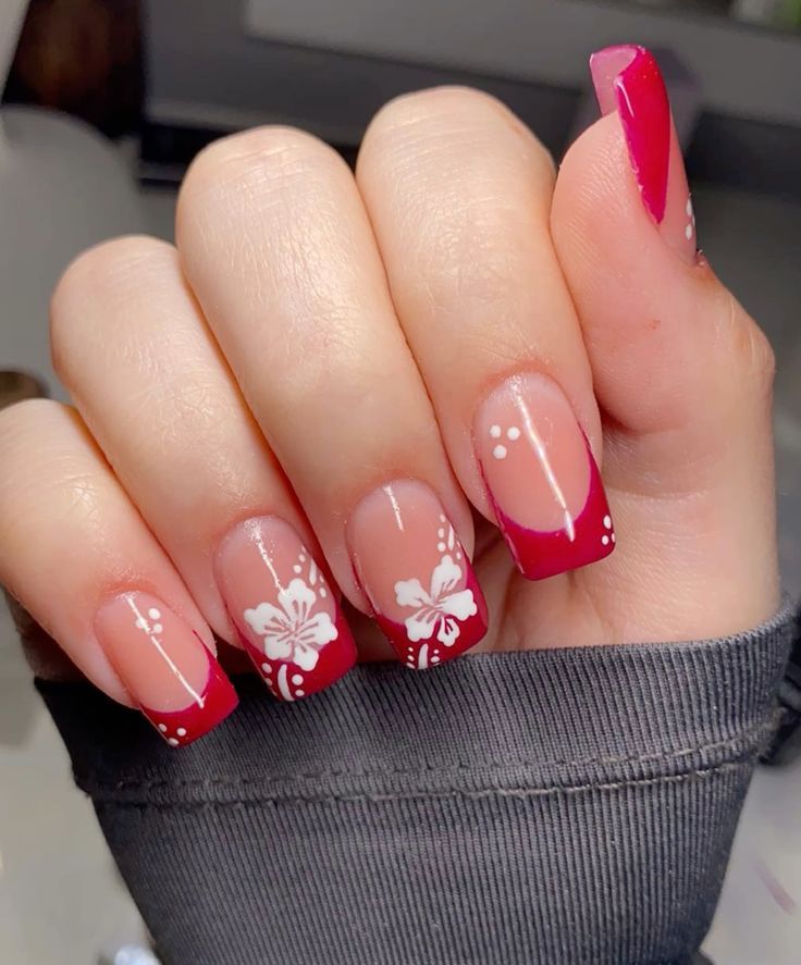 Sophisticated Nail Design: Bold Red Tips with Nude Base and Elegant Floral Accents