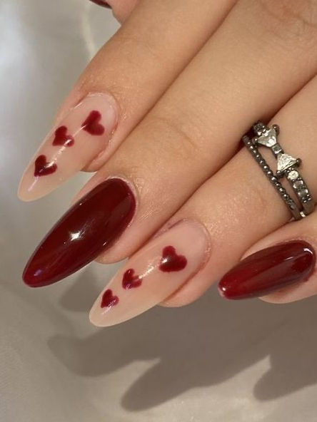 Elegant Nail Art: Glossy Crimson and Nude Tips with Hand-Painted Hearts