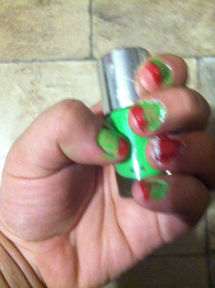 Festive Colorful Nail Design with Vibrant Green Base and Playful Red Accents.