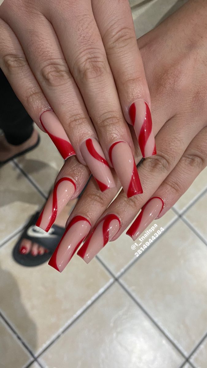 Bold Sophistication: Elegant Red and Nude Nail Design with Striking Twisted Stripes.