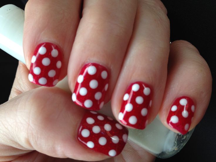 Cheerful Vibrant Red Nail Design with Whimsical White Polka Dots.