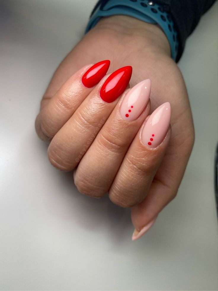 Elegant Nail Design with Vibrant Red and Soft Nude Shades Enhanced by Glossy Finish and Playful Accent Dots.