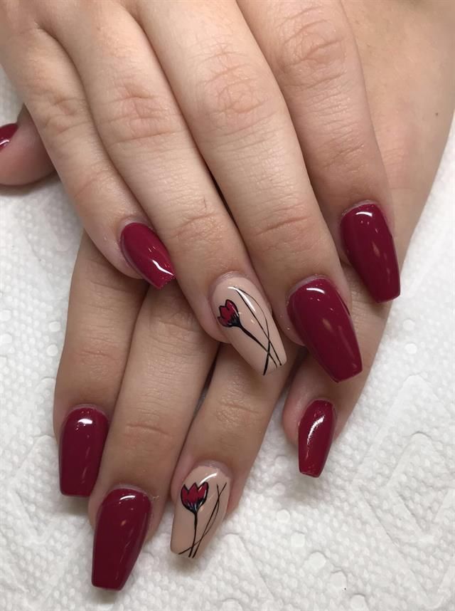 Sophisticated Deep Red Nail Design with Delicate Floral Accents.