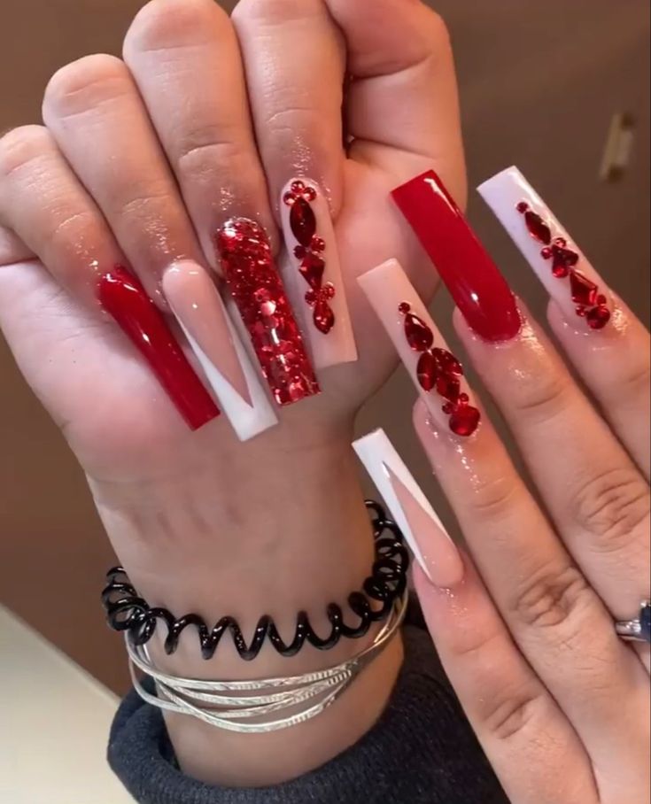 Bold Red and White Glamorous Nail Design: A Chic Blend of Lengths, Glossy Finishes, and Sparkling Embellishments.