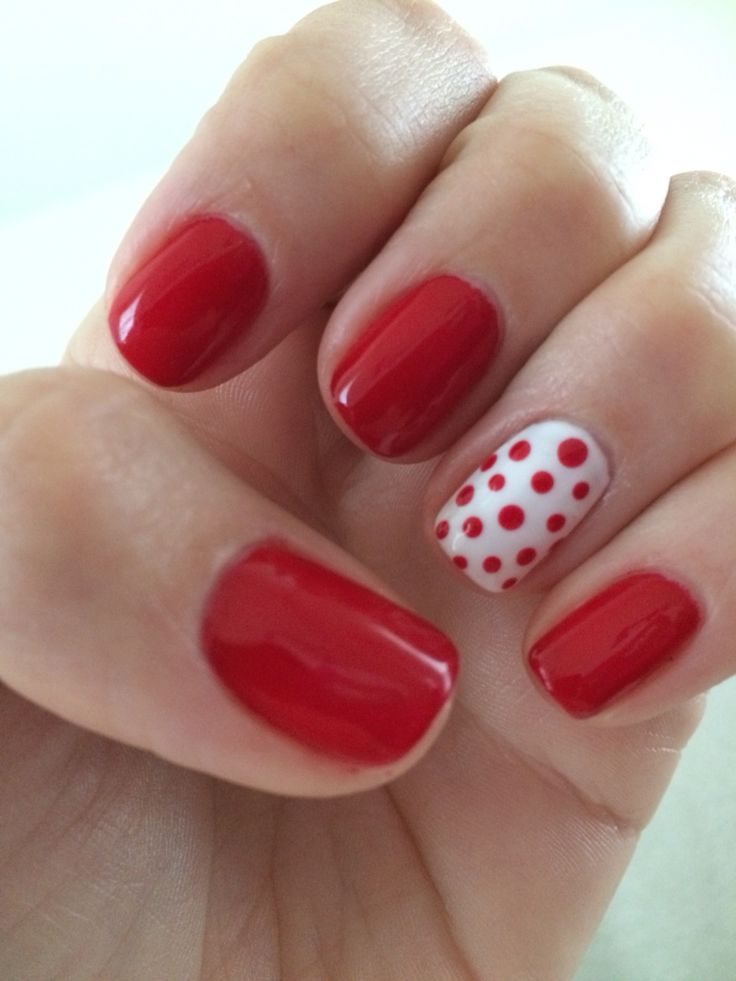 Playful Polka Dot Red Manicure: A Bold and Cheerful Accent for Any Outfit.