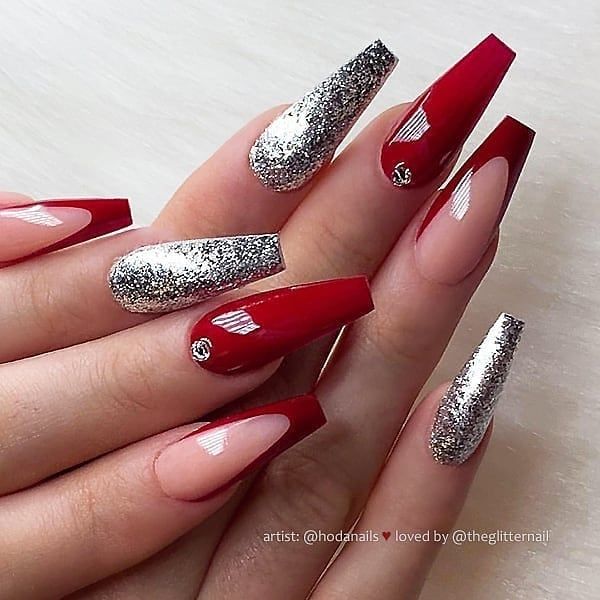 Dramatic Stiletto Nail Design: Bold Deep Red and Shimmering Silver Accents for Any Occasion.