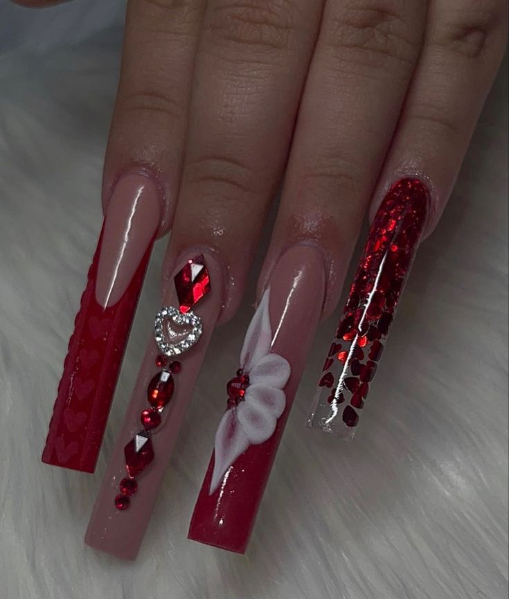 Vibrant Red and Nude Nail Design with Intricate Details and Romantic Motifs.