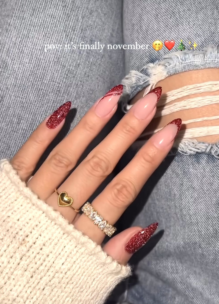 Sophisticated November Nail Design: Almond-Shaped Nails with Deep Red Glitter Gradient and Elegant Accessories.