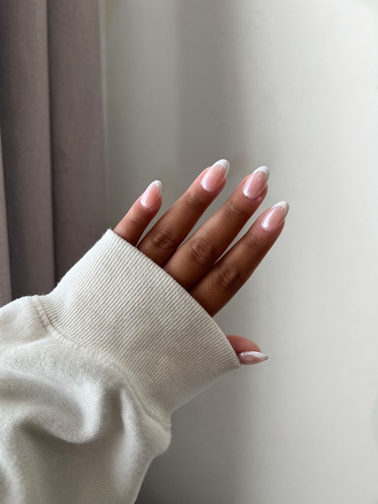 Sophisticated French Tip Nail Design with Soft Pink Base and Elegant Elongated Shape