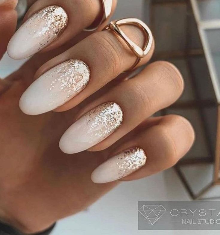 Chic Ombre Nail Design with White-Nude Gradient and Gold Glitter Accents.