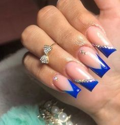 Striking Blue Acrylic Nails: Elegant Design with Bold Gem Accents