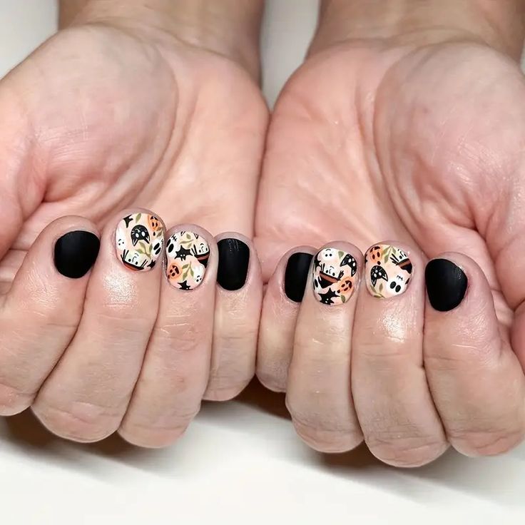 Chic Matte Black Nail Design with Playful Patterned Accents