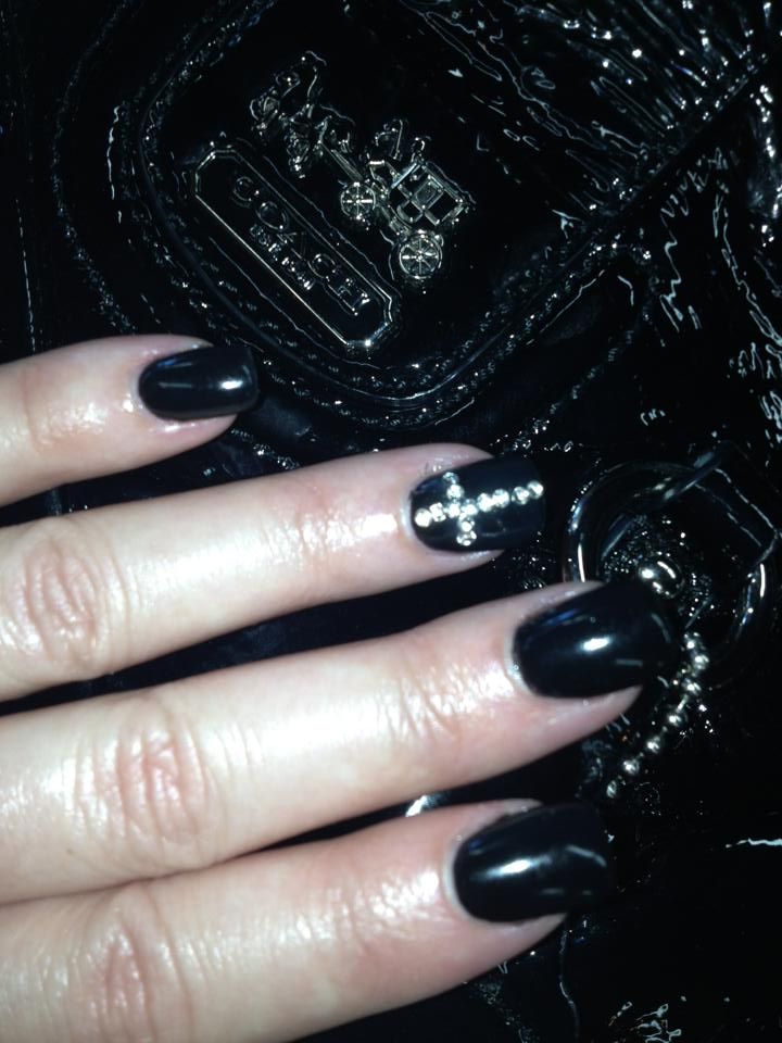 Sophisticated Black Nails with Shimmering Rhinestones: A Glamorous Fashion Statement for Any Occasion.