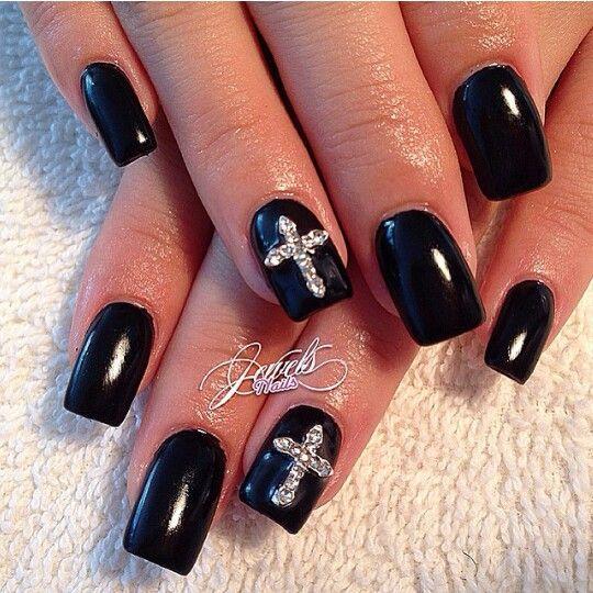 Dramatic Glossy Black Nails Enhanced with Sparkling Rhinestone Crosses for Elegant Sophistication.