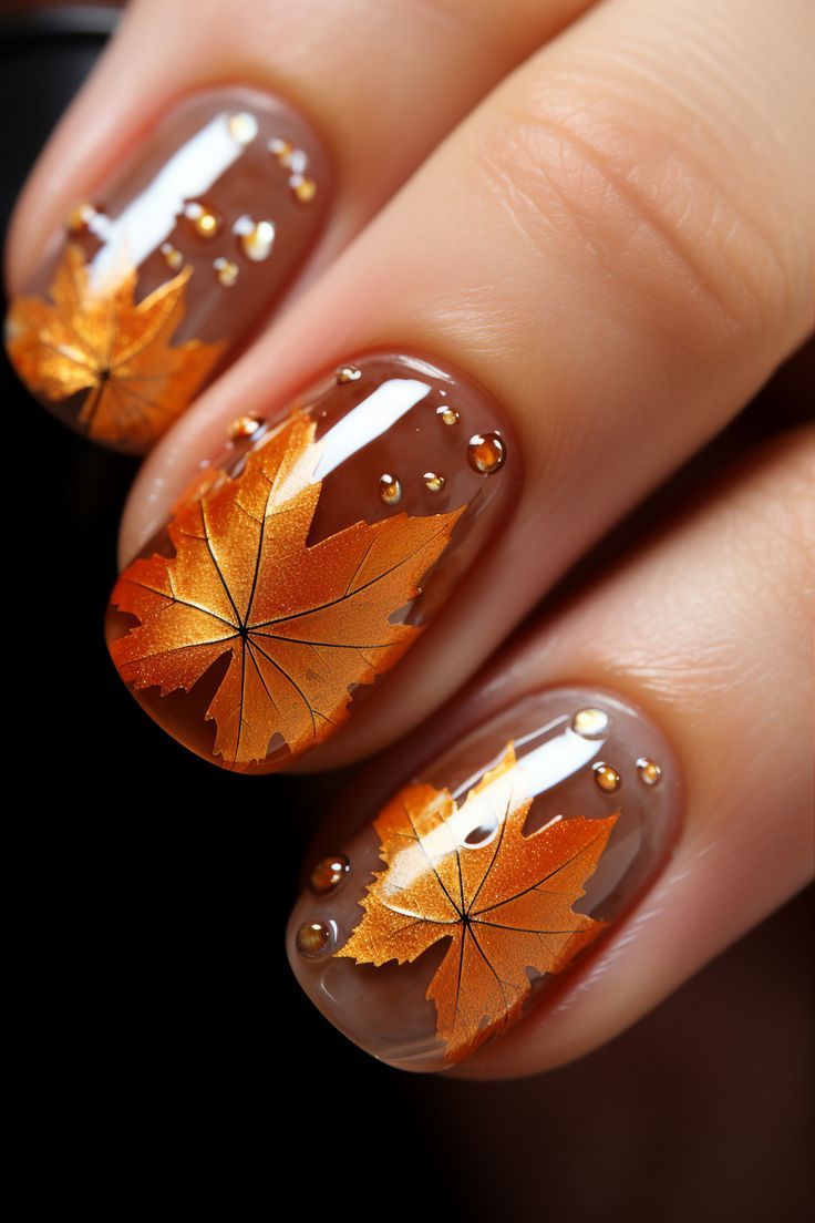 Chic Autumn-Inspired Nail Design with Intricate Orange Leaf Patterns and Glossy Translucent Base.