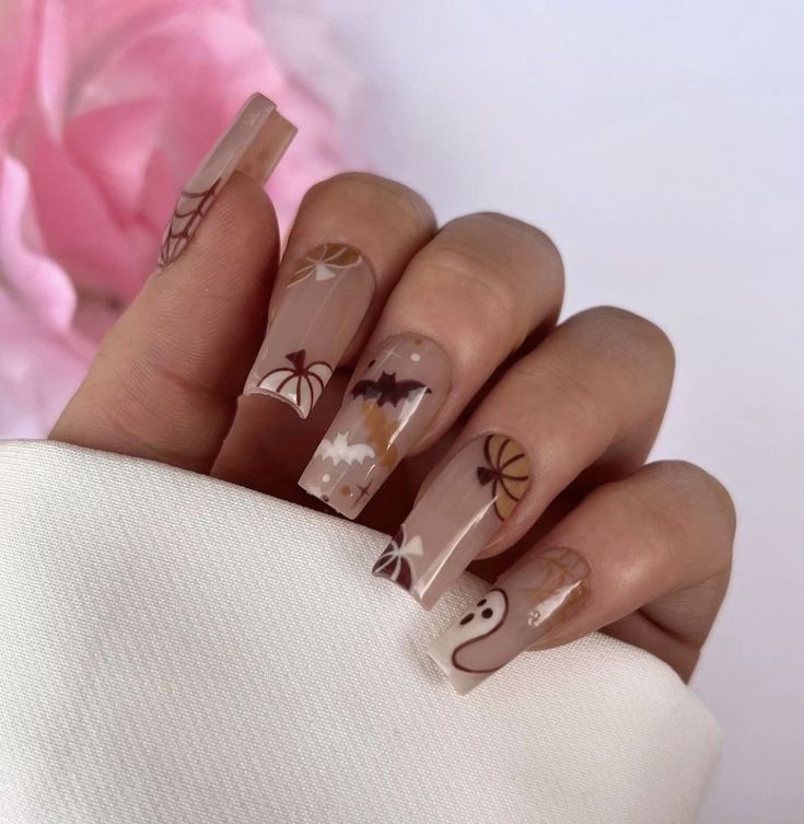 Whimsical Autumn Nail Design: Elegant Neutral Base with Festive Ghosts, Bats, and Spider Webs