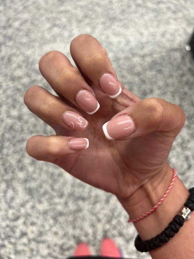 Chic Nude and White Nail Design with Delicate Heart Accents