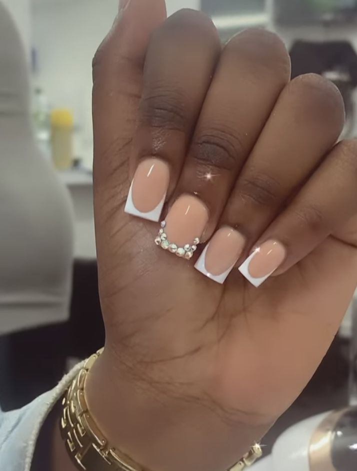 Sophisticated Soft Nude Nail Design with White Tips and Rhinestone Accents