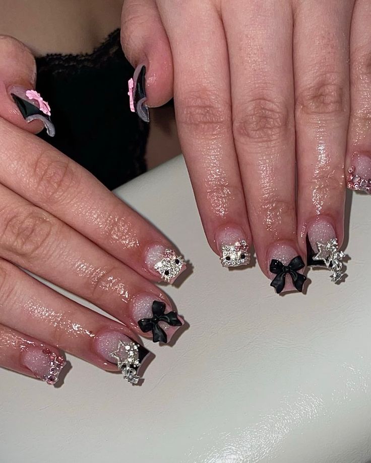 Elegant Nail Design with Delicate Bows and Sparkling Accents for a Trendy Look.