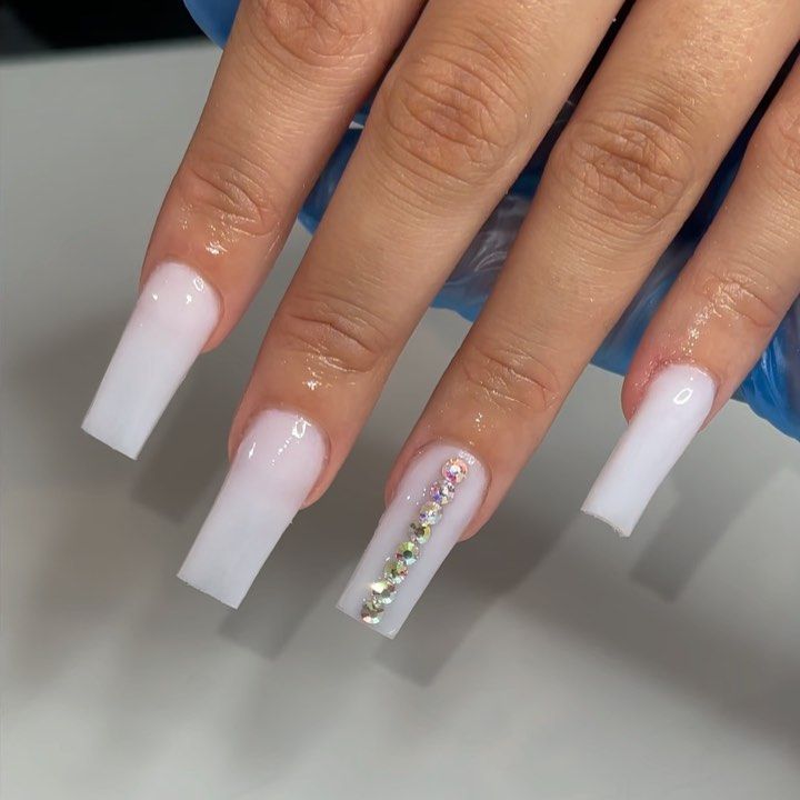 Chic Ombre Nails: Soft White to Sheer Pastel with Crystal Accents and Square Tips.