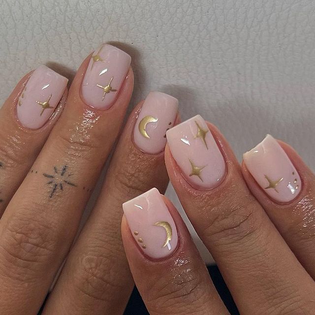 Ethereal Pink Nail Design with Minimalist Gold Accents and Whimsical Celestial Details.