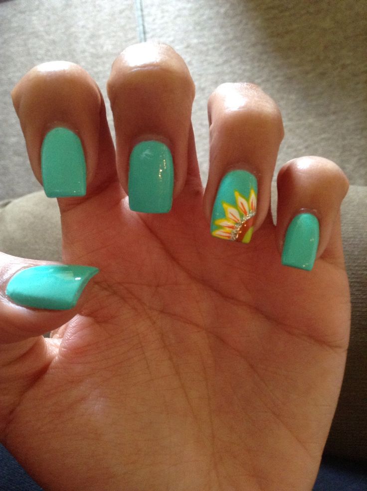 Playful Turquoise Nails with Cheerful Sunflower Accent for a Summery Vibe.