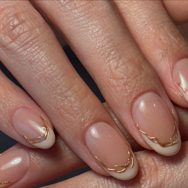 Sophisticated Elegant Nude Nail Design with Classic French Tips and Gold Accents