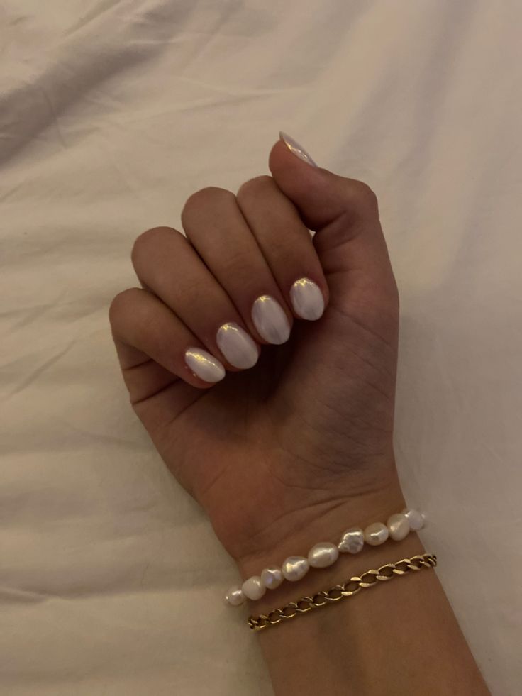 Refined Oval White Pearlescent Manicure Accentuated by Elegant Accessories.