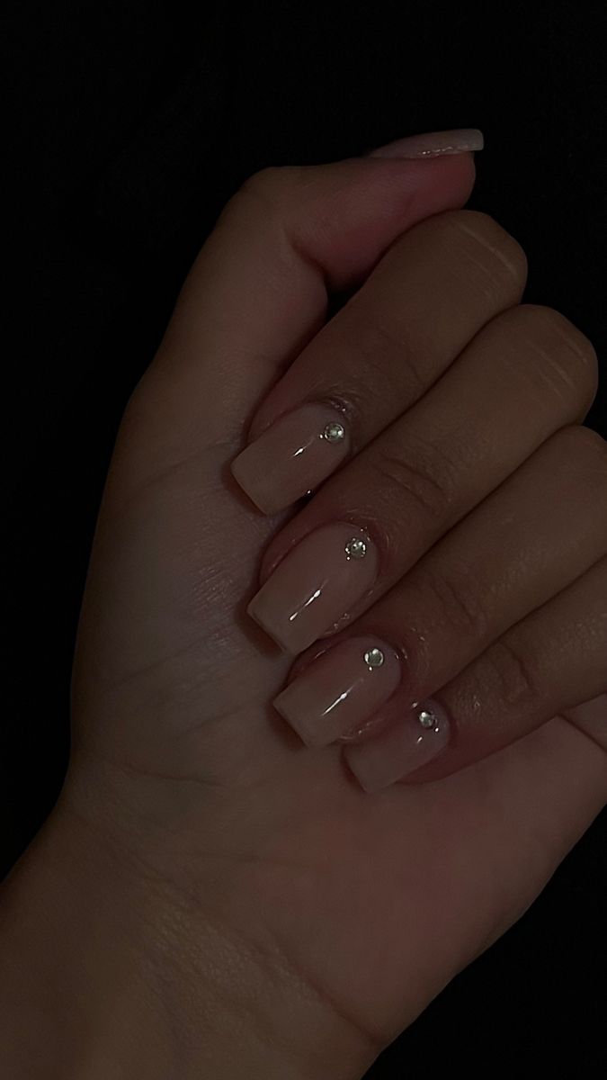 Chic Elegant Nude Nail Design with Subtle Shine and Gemstone Accents