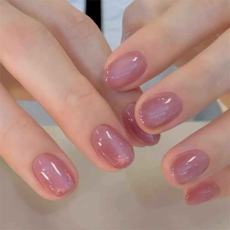 Elegant Soft Pink Nail Design with Glossy Finish and Subtle Gradient Shimmer.