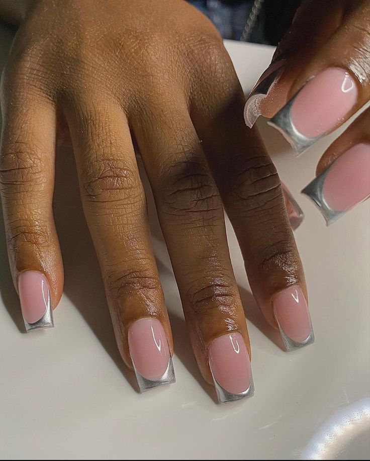 Sophisticated Elegant Nail Design: Soft Pink Base with Striking Silver Tips.