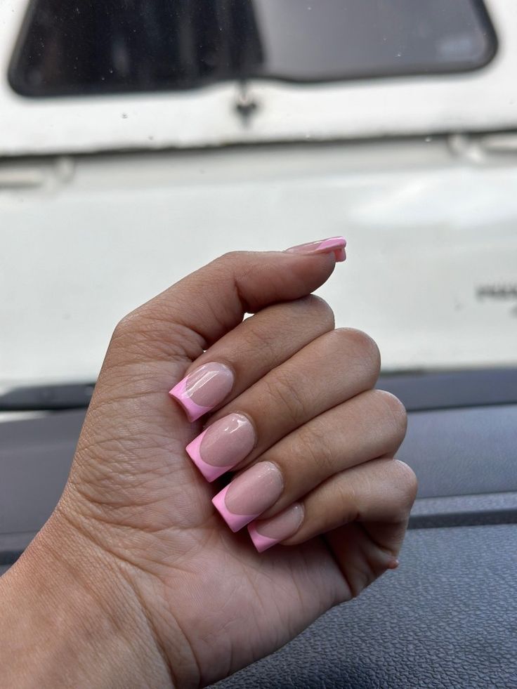 Elegant French Tip Manicure with Soft Pink Accents and Nude Base.