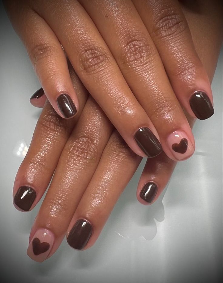 Chic Brown and Nude Nail Design with Heart Motif for a Playful, Warm Look.