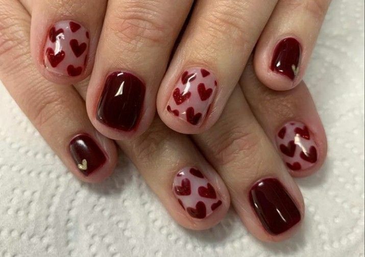 Romantic Nail Design with Deep Maroon, Soft Pink, and Heart Accents.