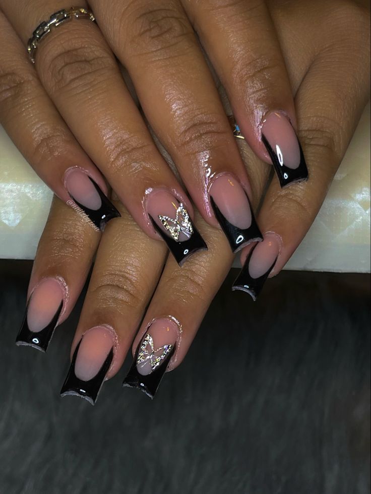 Elegant Nude and Black Nail Design with Glossy Finish and Butterfly Accents