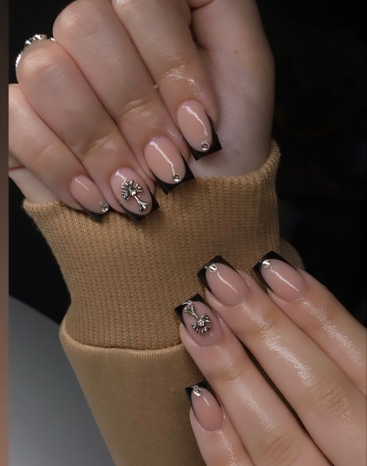 Chic Nude and Black Nail Design with Sophisticated Accents.