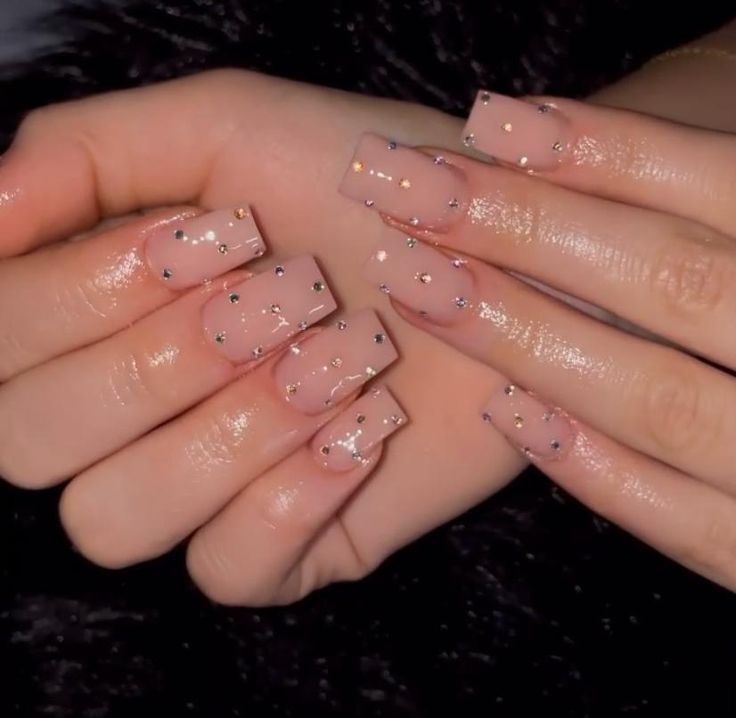 Chic Sheer Nude Nail Design with Glitter Accents for Elegant Occasions