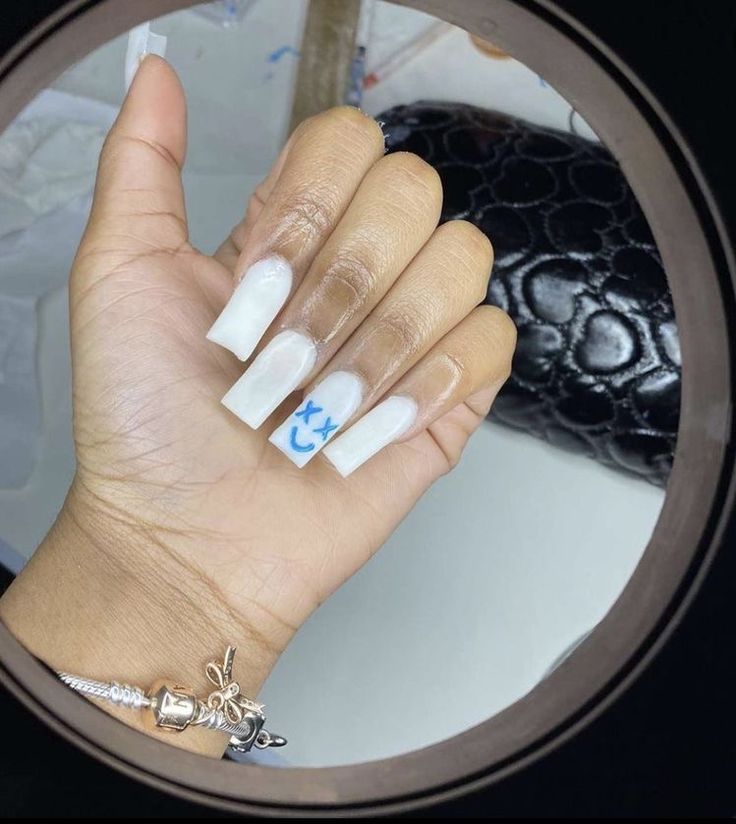 Chic Gradient Nail Design with Playful Blue Accents for a Modern, Whimsical Style.