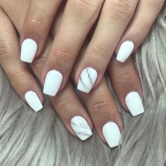 Sophisticated White Manicure with Glossy Finish and Marble Accent.