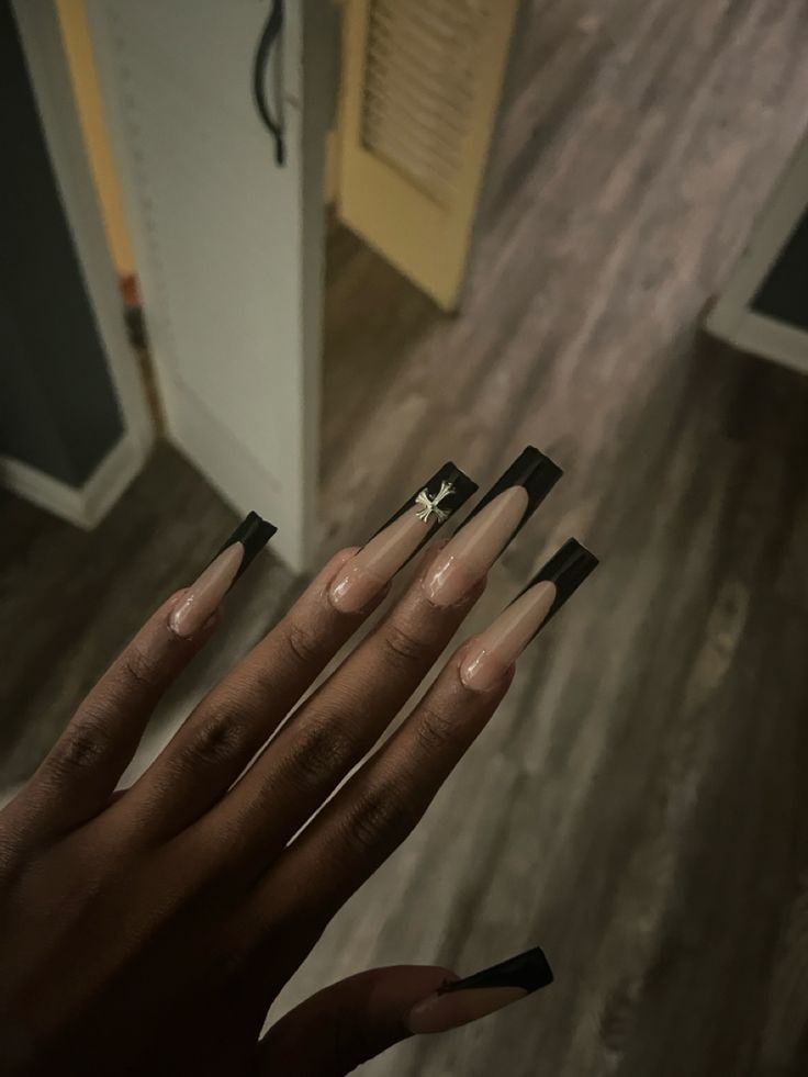 Elegant Long Nails with Striking Nude and Black Contrast Showcase Artistic Flair.