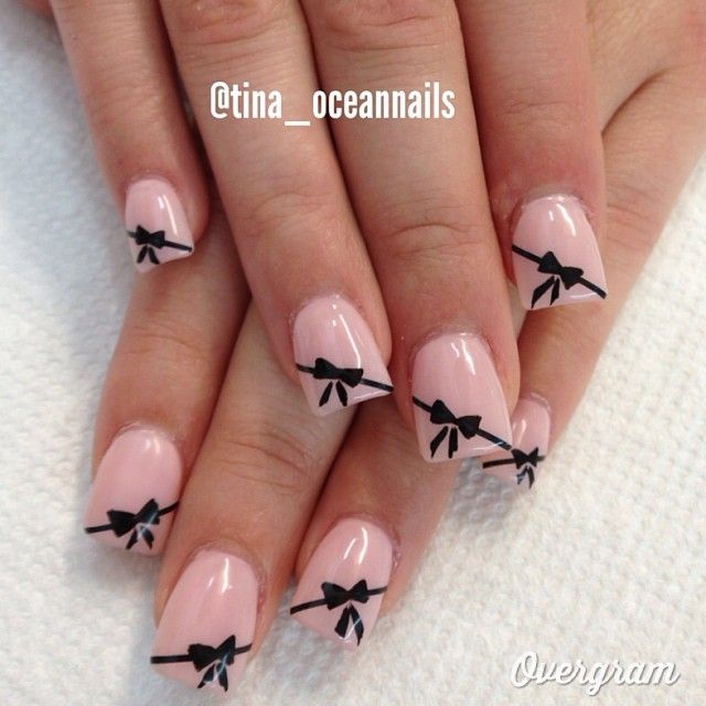 Chic Whimsy: Elegant Nude Nail Design with Delicate Black Bows