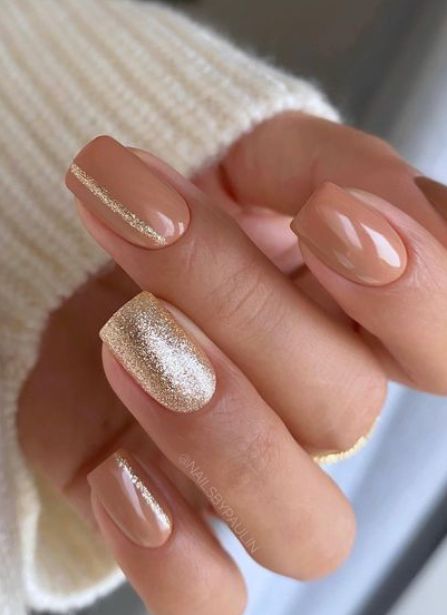 Chic Nude and Gold Nail Design with Modern Geometric Accents.