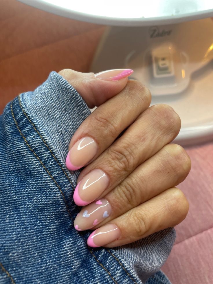 Chic Nude and Pink Heart Accent French Manicure: A Whimsical Twist on Classic Elegance.