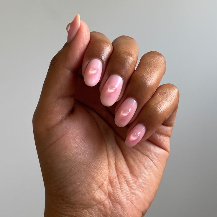 Chic Pastel Nail Design with Textured Raised Dots on Soft Pink Base.