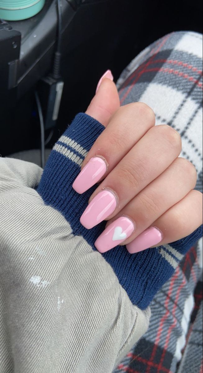 Charming Chic Pastel Pink Nails with Playful Heart Design for a Fun, Feminine Look.