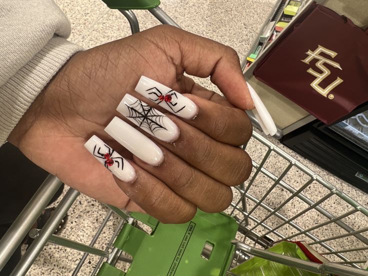 Stylish Halloween-Inspired Nail Design with Long White Tips and Intricate Spider Web Motifs